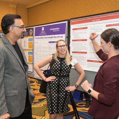Claire Ciarkowski and Kencee Graves, hospitalists from University of Utah Health, discuss their award winning quality improvement work with Gulshan Sharma, vice president and chief medical and clinical innovation officer at The University of Texas Medical Branch.
